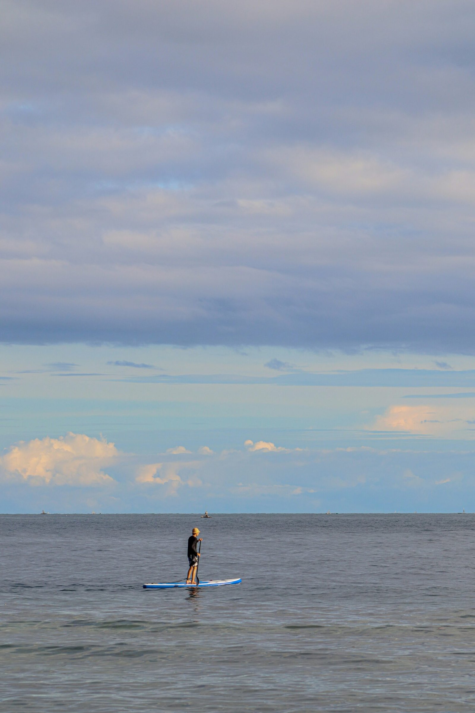 man in black shorts standing on sea shore during daytime
